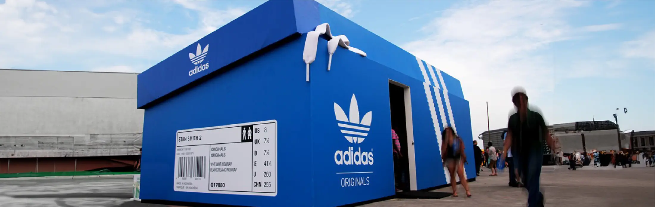 Blue shoebox-shaped Adidas Originals pavilion at a festival (Adidas Ghettorama)