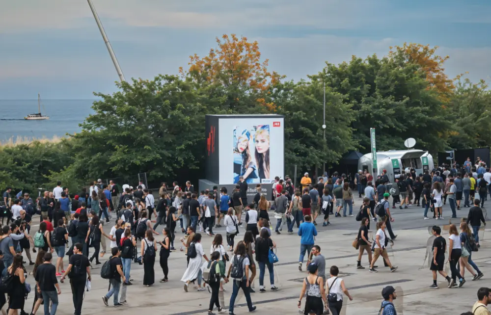 Crowd of festival visitors in front of an H&M video wall at Primavera Sound