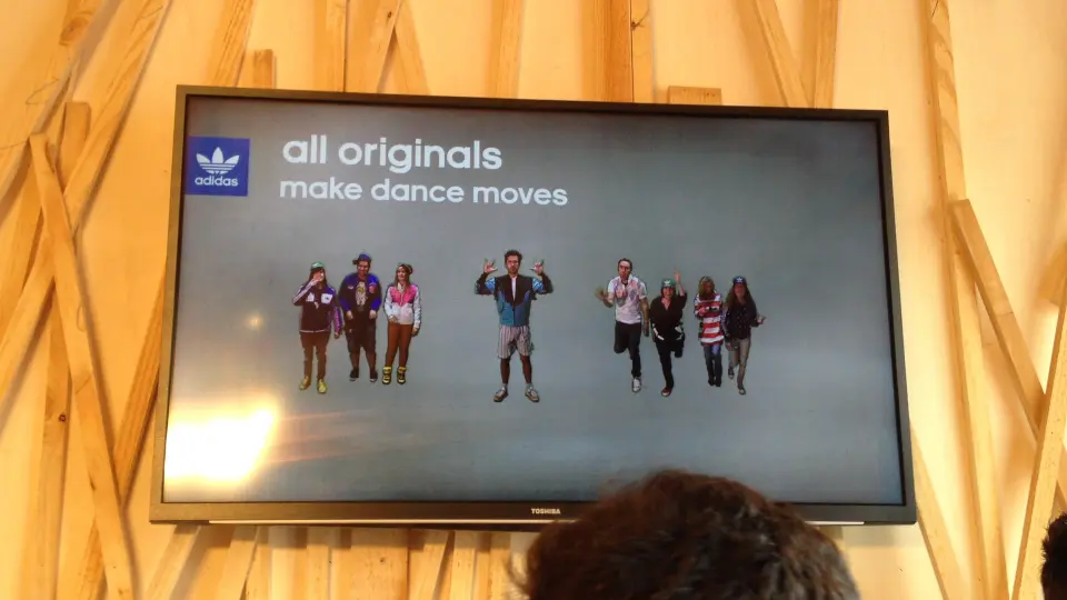 Screen showing a group of silhouetted dancers with the text all originals make dance moves