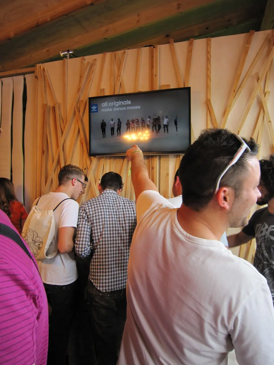 Visitors gathered around a screen showing the dance moves recorded in the booth