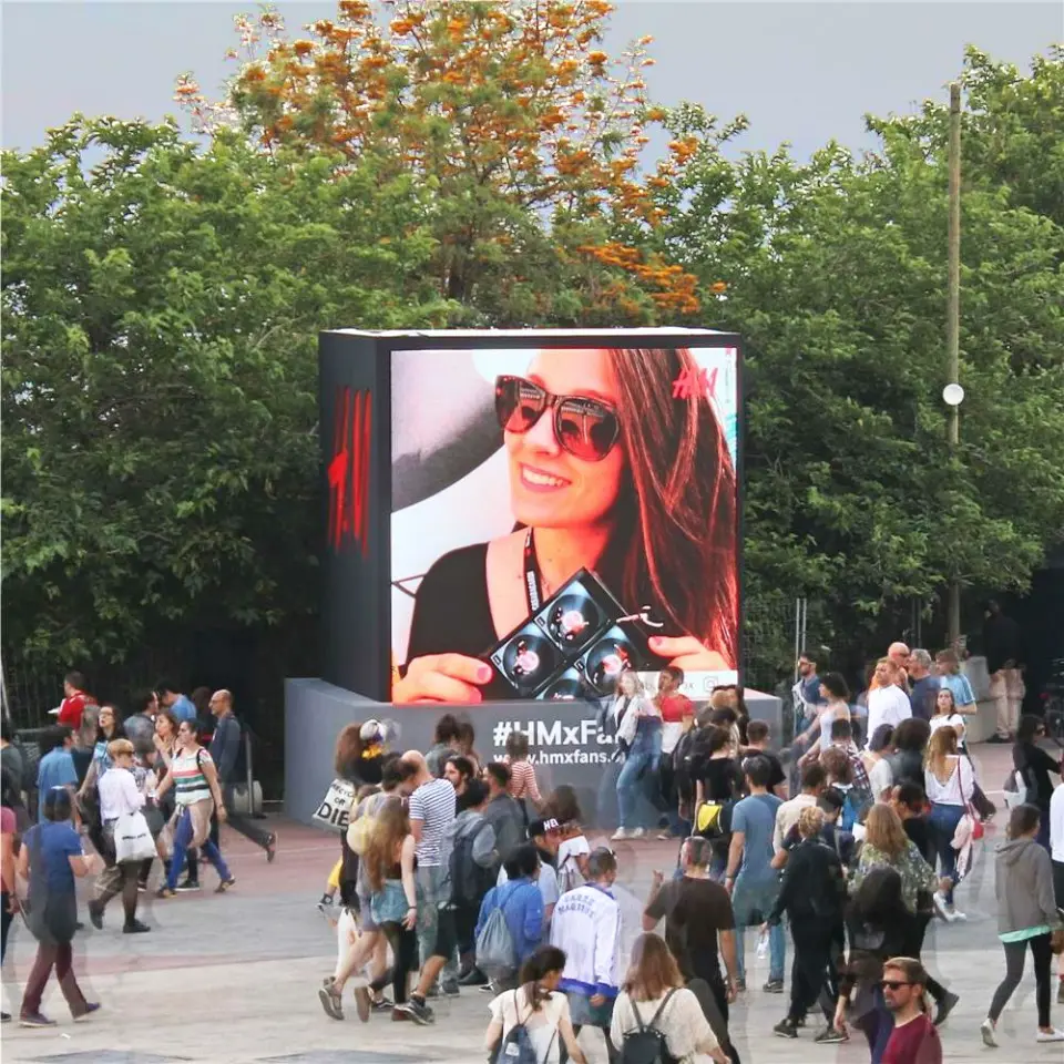 Close-up of the H&M video wall cube showing a giant selfie of a woman in sunglasses