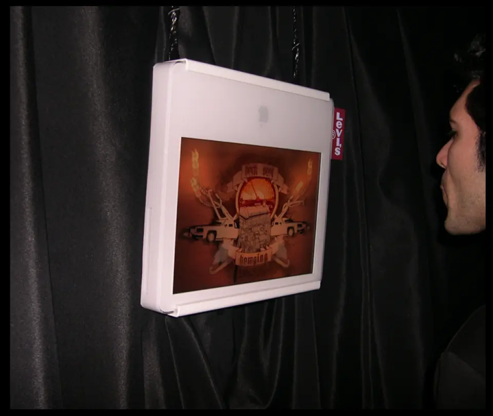 Person looking at a framed interactive screen hanging on a black wall