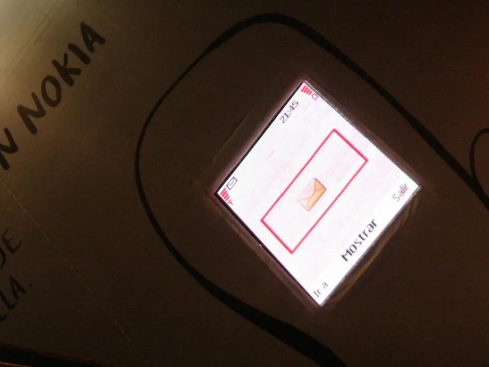 Close-up of the lit Nokia screen showing a message on the building