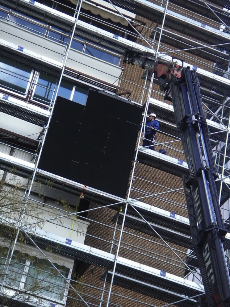 LED screen being installed on a building covered in scaffolding