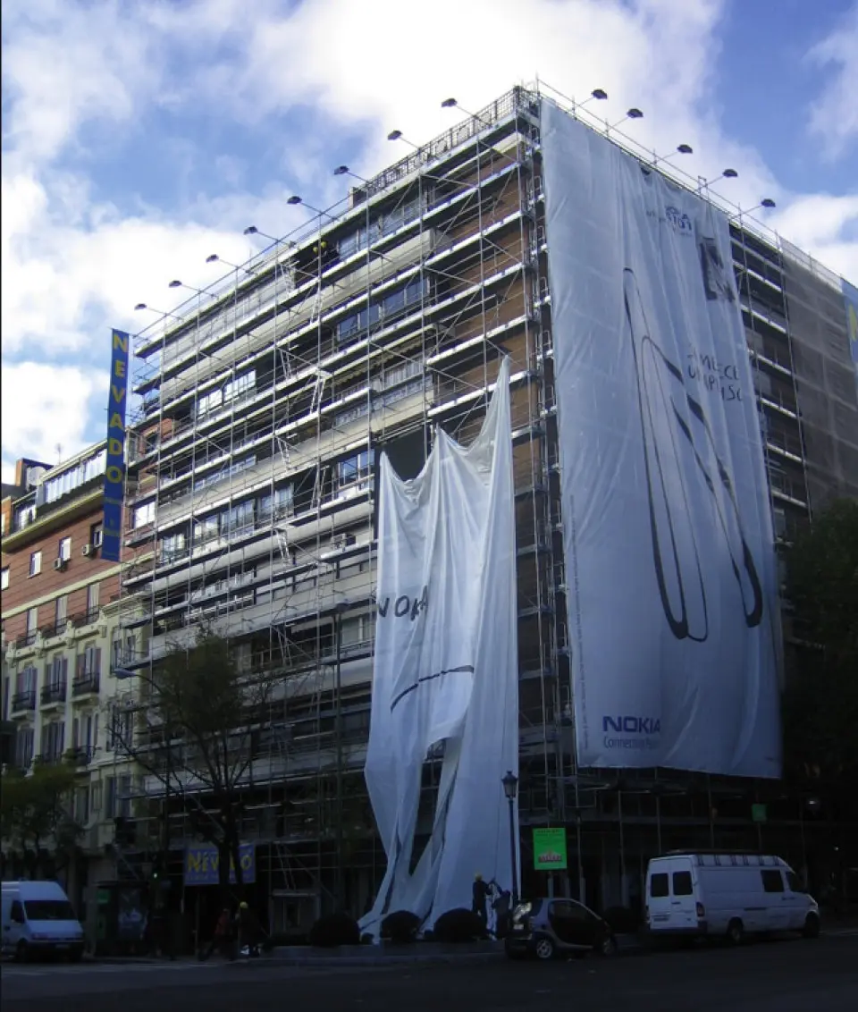 Building covered by a large banner with the Nokia LED screen in the center of Madrid