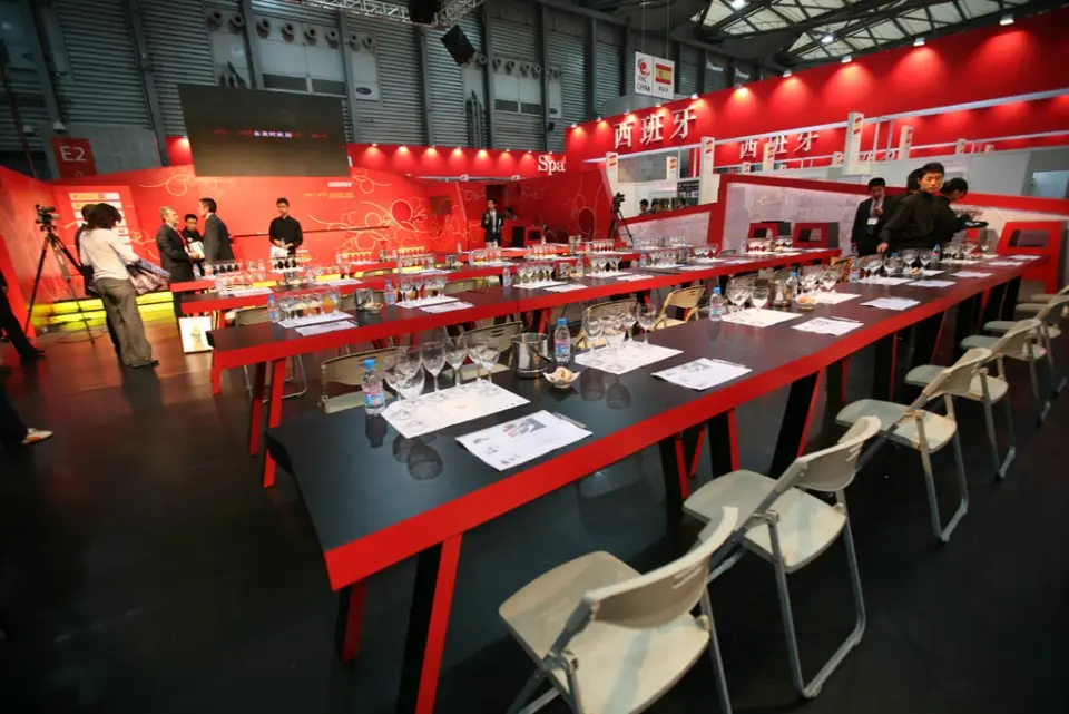 Long tasting table with glasses in the red Spanish Culinary Area